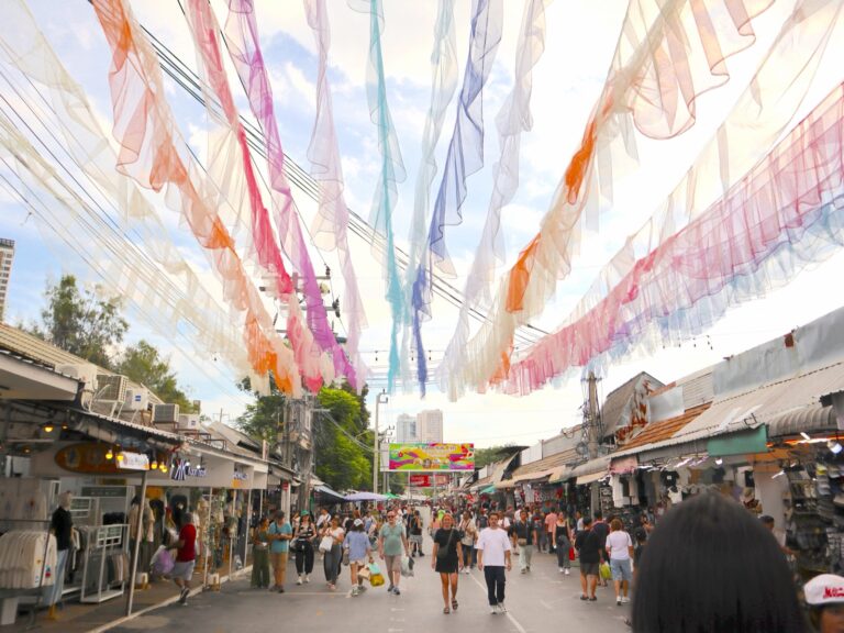 Colorful fabric streamers hanging above a shopping street at Chatuchak