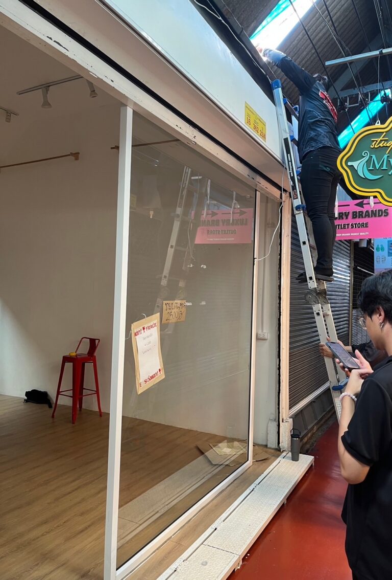 Worker preparing the Soi YIPUN storefront before interior construction