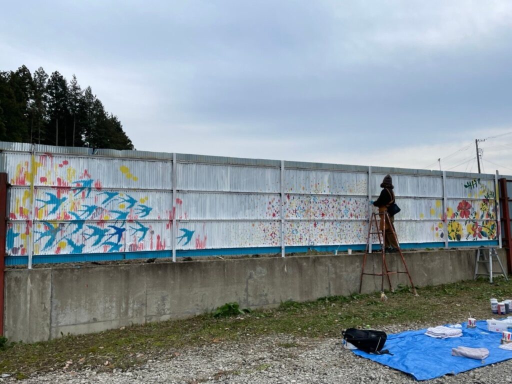 A large hand-painted mural by Kotori/KTR on an exterior wall, completed view
