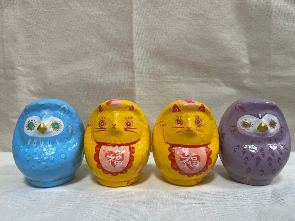 Four differently painted Daruma art pieces by Kotori/KTR