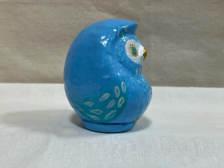 Blue owl Daruma art piece by Kotori/KTR, side and back view showing the eye motif