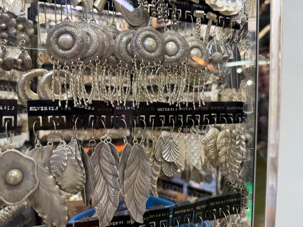 Detailed silver earrings displayed at Orange Karen Silver