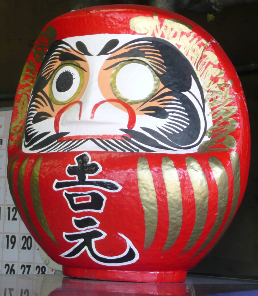 Traditional red Daruma with one eye filled in
