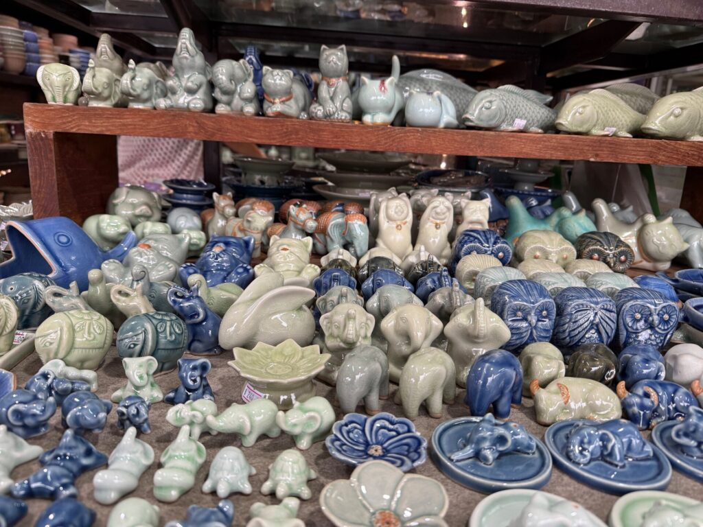 Elephant, owl and fish ceramic figures on the shop shelves