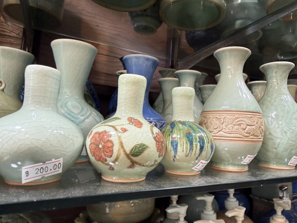 Blue-green celadon vases displayed with price labels at Celadon Shop