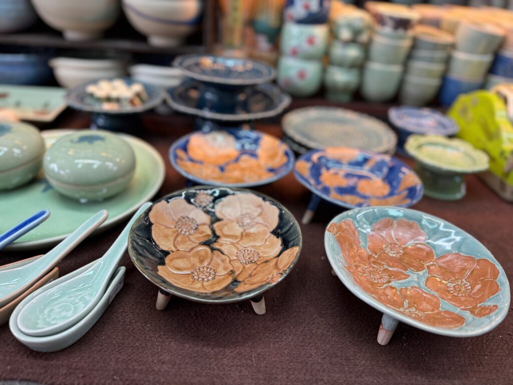 Floral ceramic plates and spoons displayed at Celadon Shop