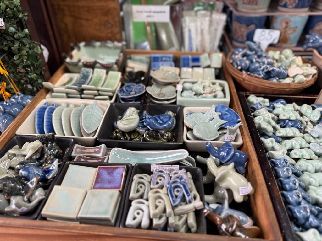 Small ceramic souvenirs and tableware displayed with price labels