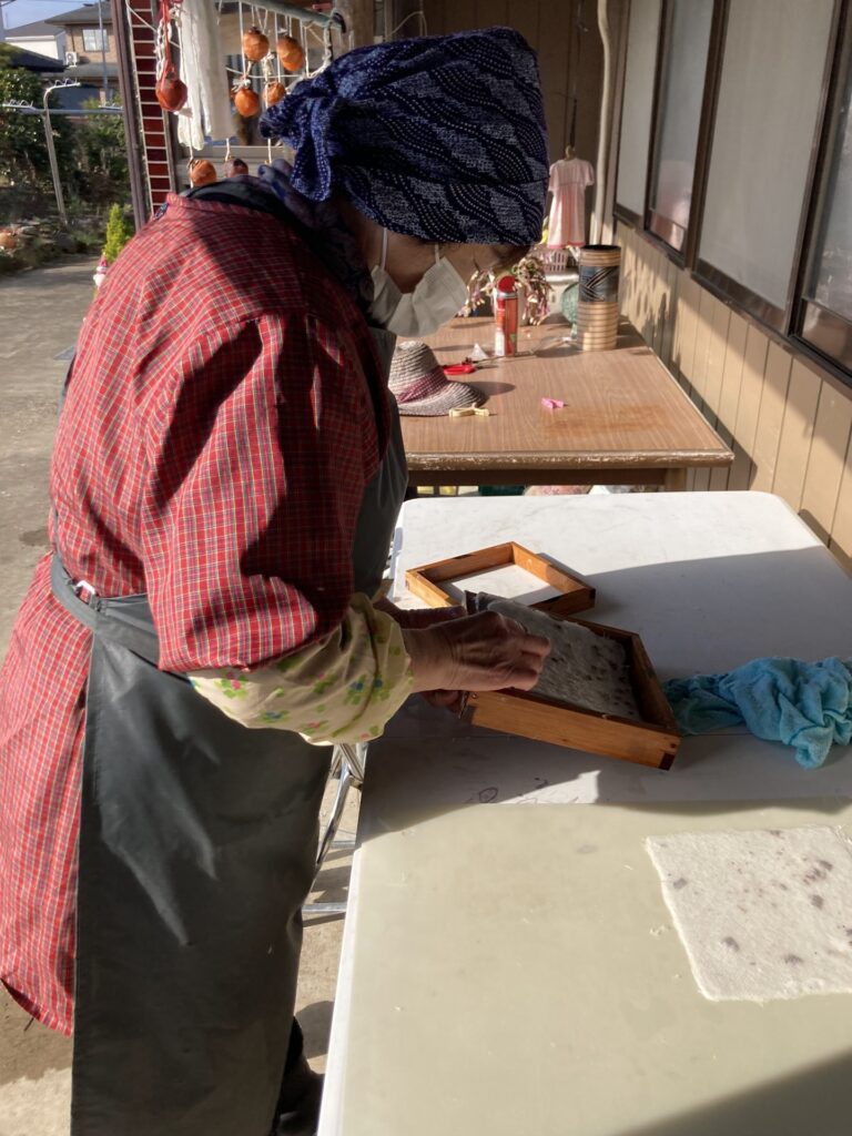 A person working with paper beside a work surface.
